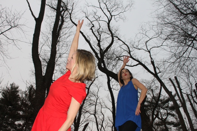 The duo of the Raving Jaynes improvise outside amongst the trees wearing red and blue tops